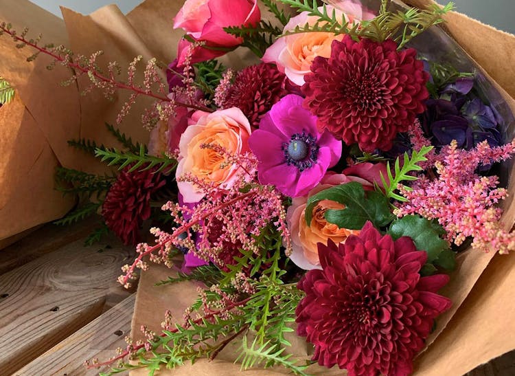 Autumn colors aplenty in this warmly red, orange and pink bouquet